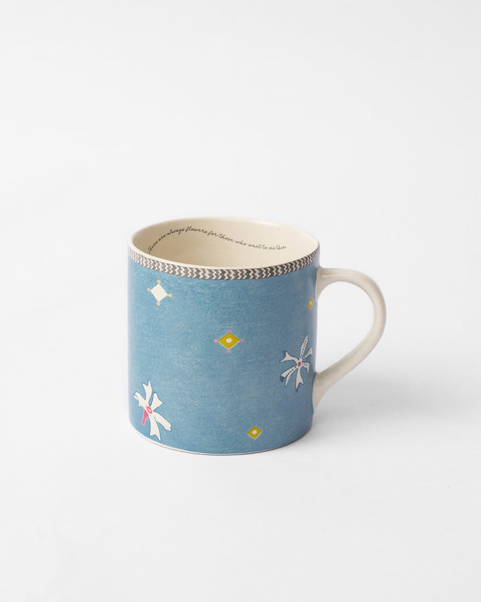 Parijat straight mug in blue with white motifs and yellow diamond accents.