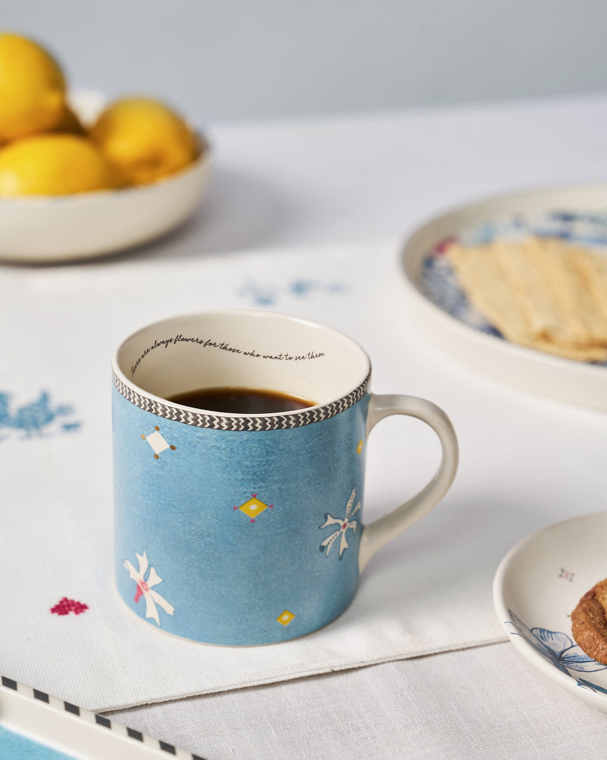 Parijat straight mug filled with coffee on a table.