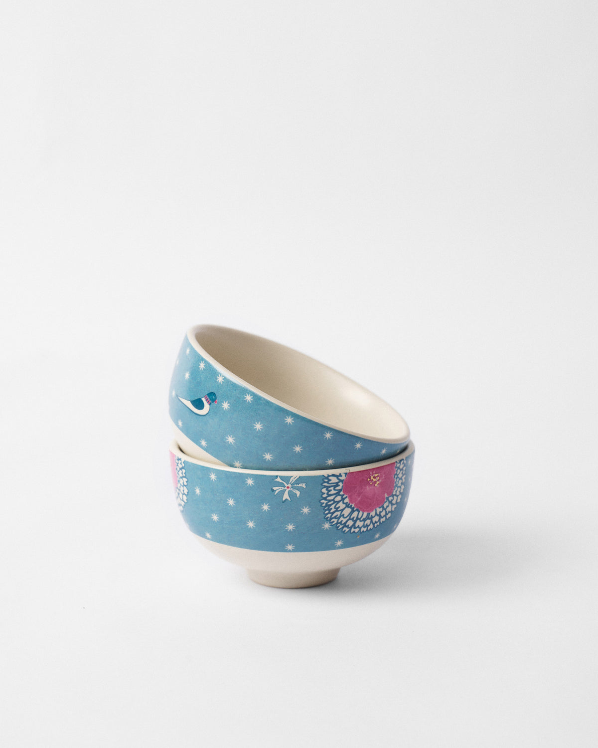 Stacked Marigold nibble bowls showing bird and pink flower prints.