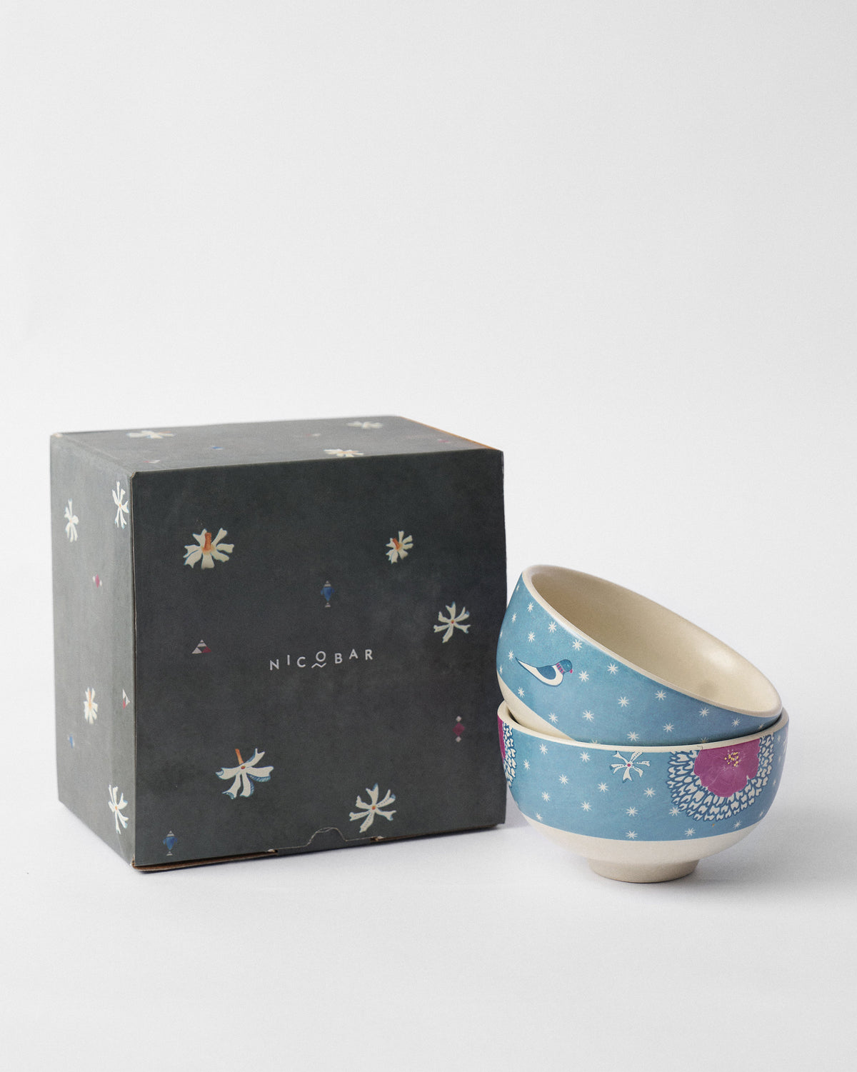 Marigold nibble bowls beside a dark Nicobar gift box.