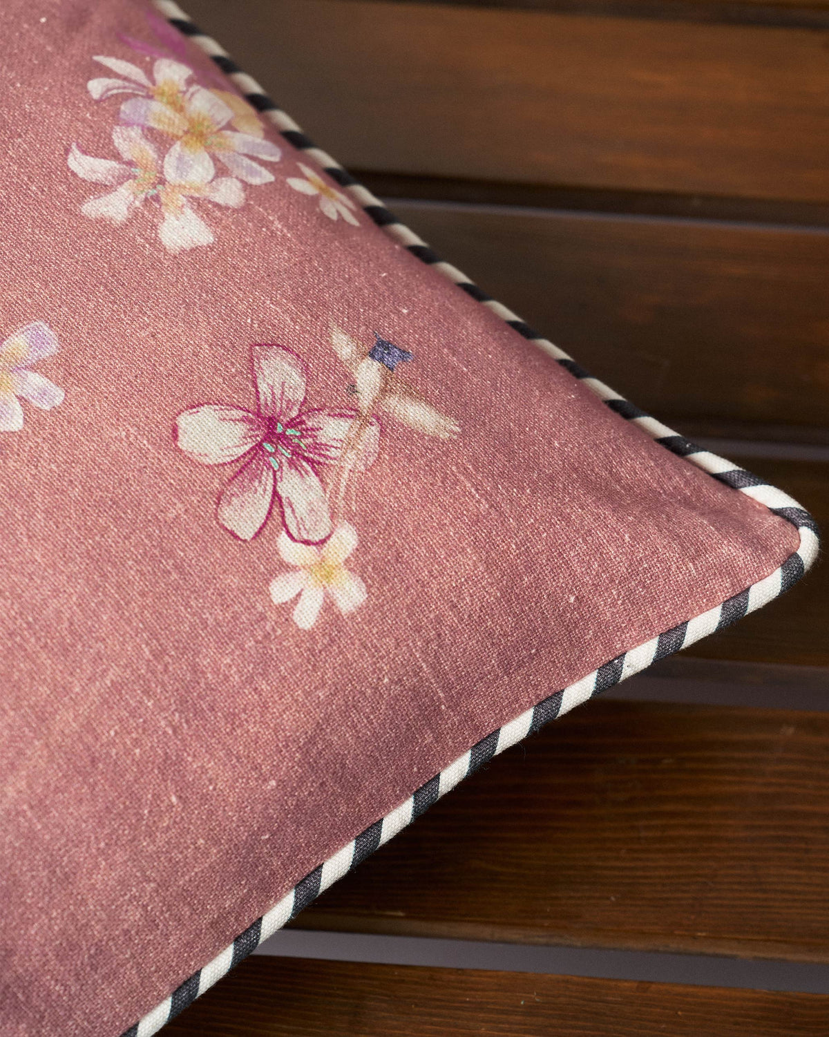 Close-up of River Tiger Cushion Cover showing its floral print and striped piping.