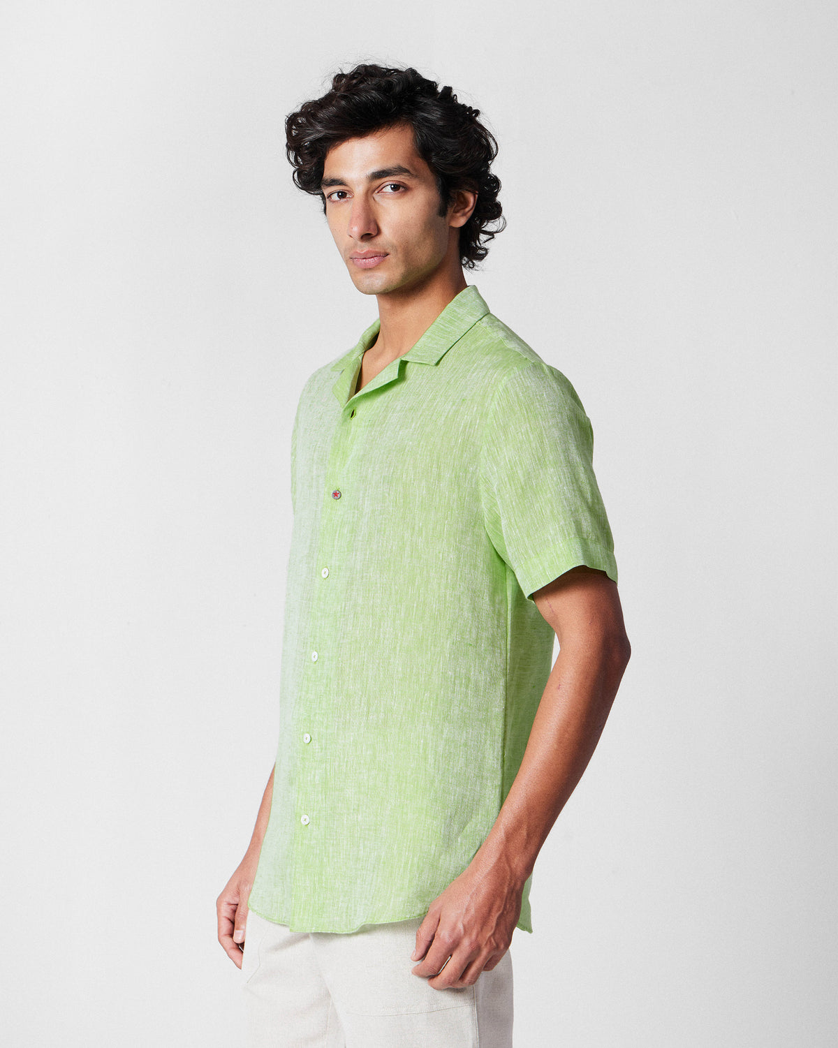 Side view of a light green Mistari shirt.