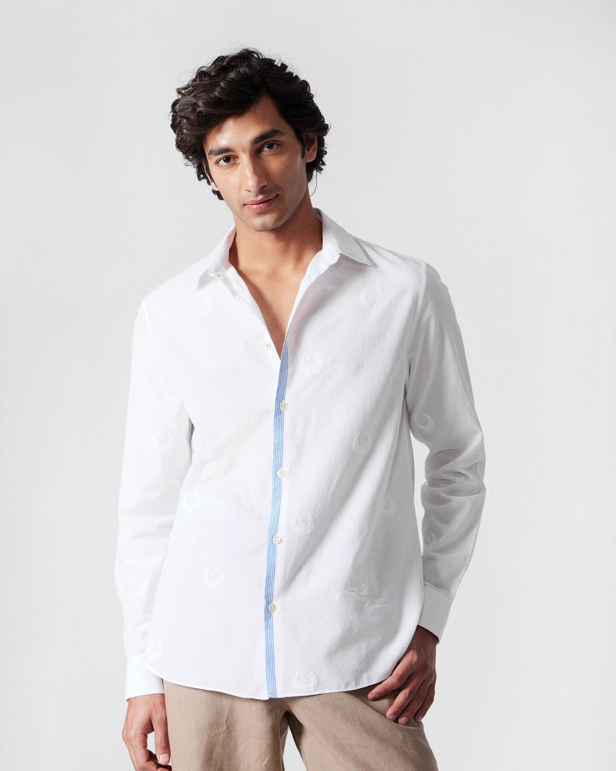 Person wearing a white Basalt shirt with blue placket selvedge.
