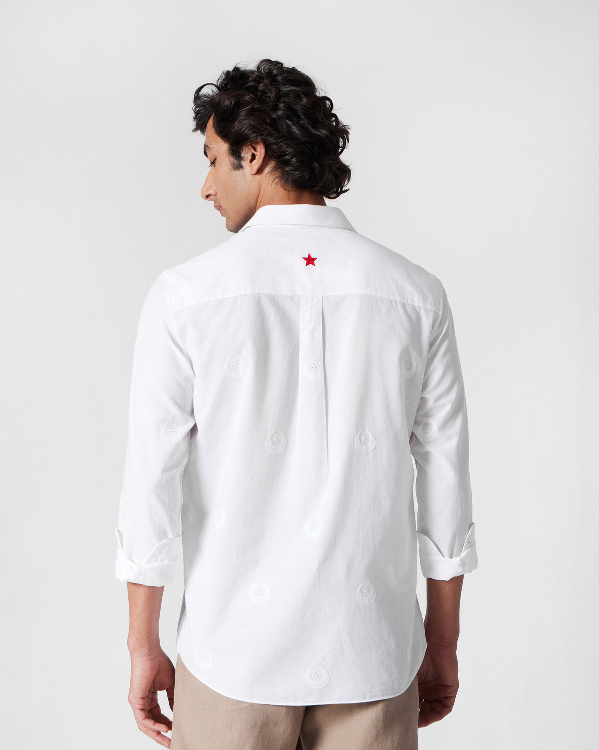 Back of a white Basalt shirt with a red star on the yoke.