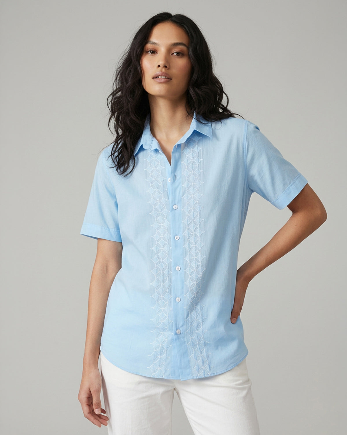 Person wearing a light blue embroidered Half Sleeve Shirt with white geometric panels.