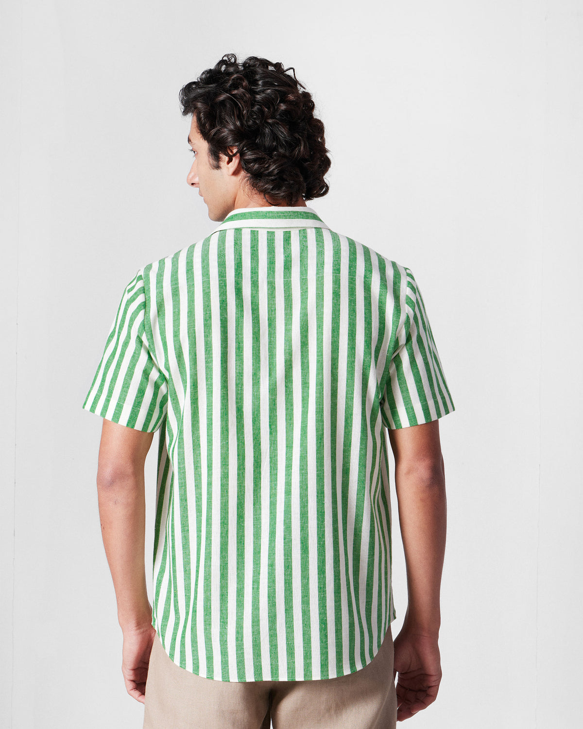 Back of a green-and-white striped half-sleeve shirt.