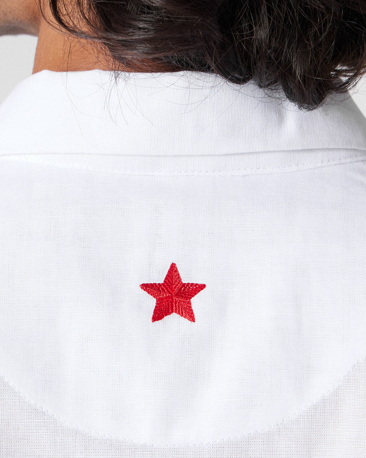 Close-up of a red star on the back of a white Delta shirt.