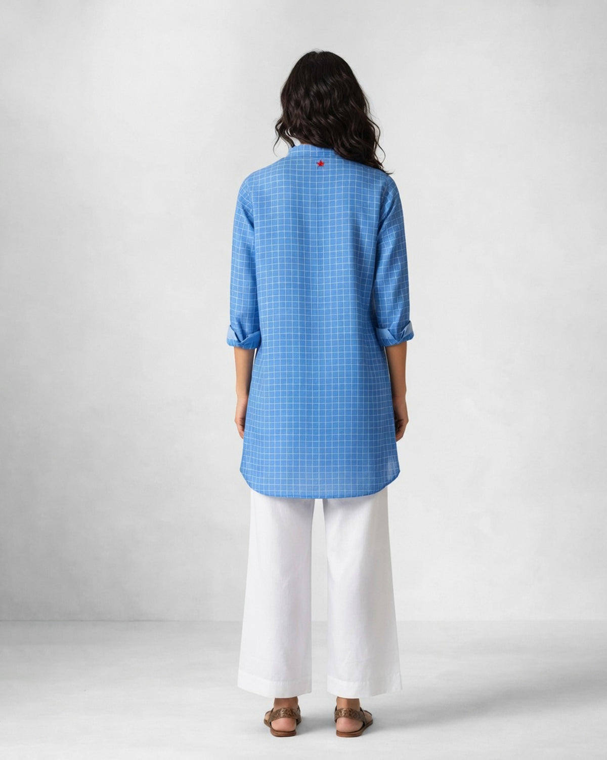 Back of a blue checked Nysa kurta worn by a person.