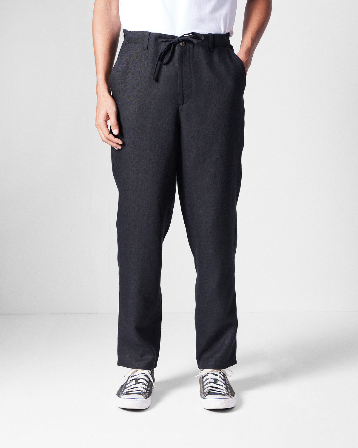 Person wearing black Karo Pants with a relaxed straight leg.