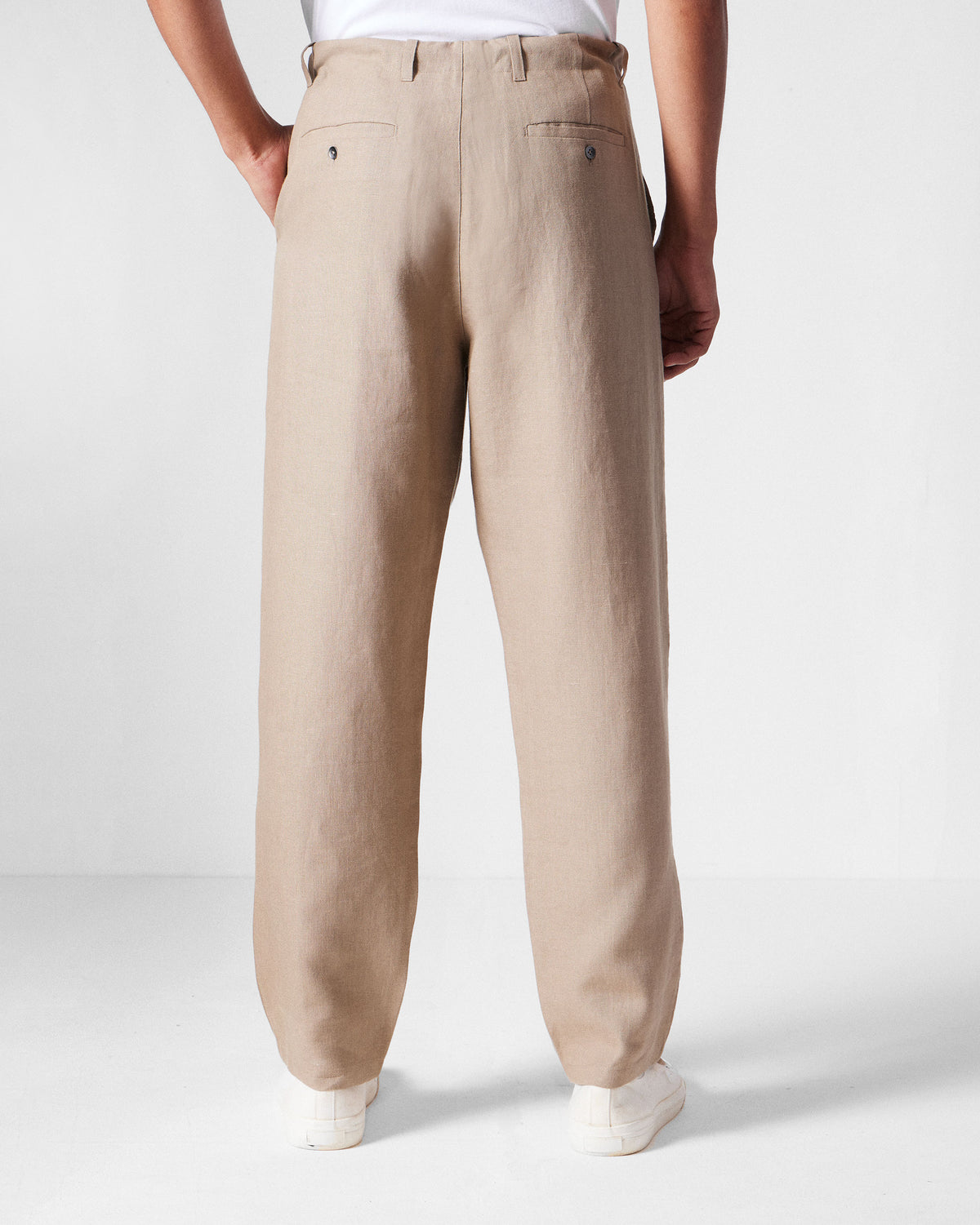 Back of light brown Karo Pants with buttoned welt pockets.