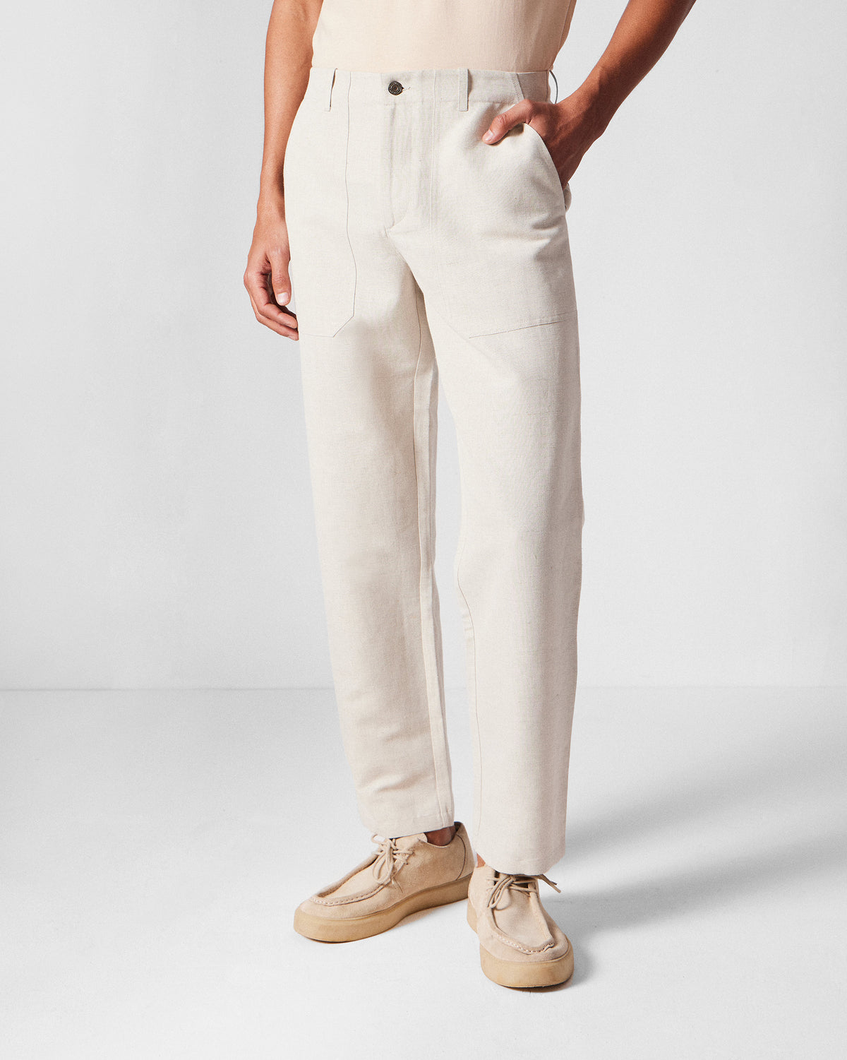 Person wearing ivory Zar Pants with front patch pockets.