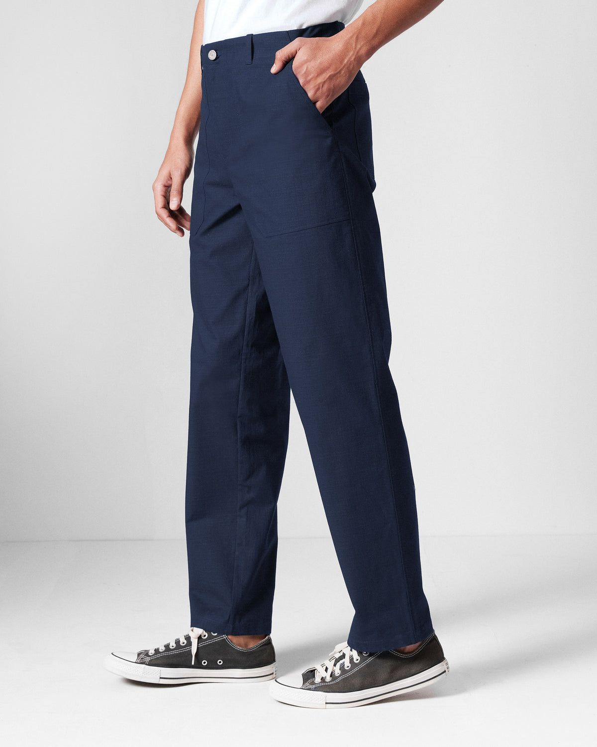 Side view of navy Zar Pants showing a straight leg and side pocket.
