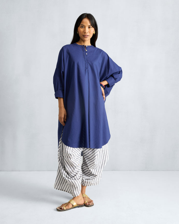Person wearing an ink blue Lazy Sunday tunic with a mandarin collar.