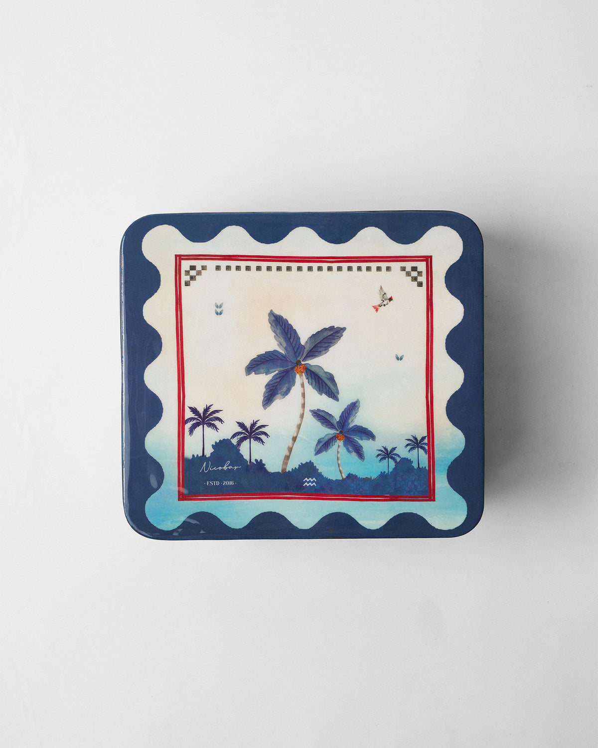 Kandy Stripes gift tin lid with blue palm trees and a navy scalloped border.