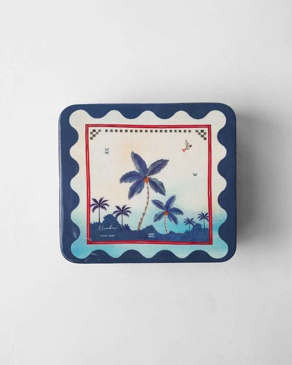 The tin lid with blue palms and a navy scalloped border