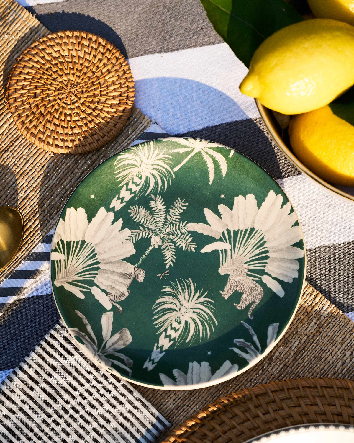 Haathi Quarter Plate on a table, with its green palm and spotted animal print.