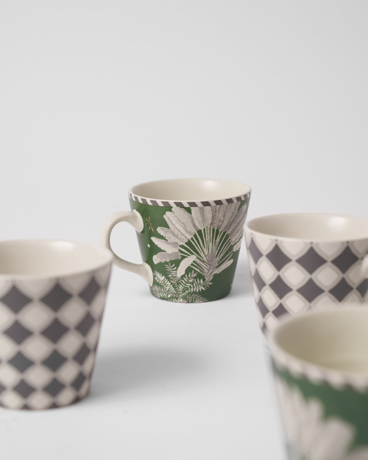 A cream palm leaf on a green cup.