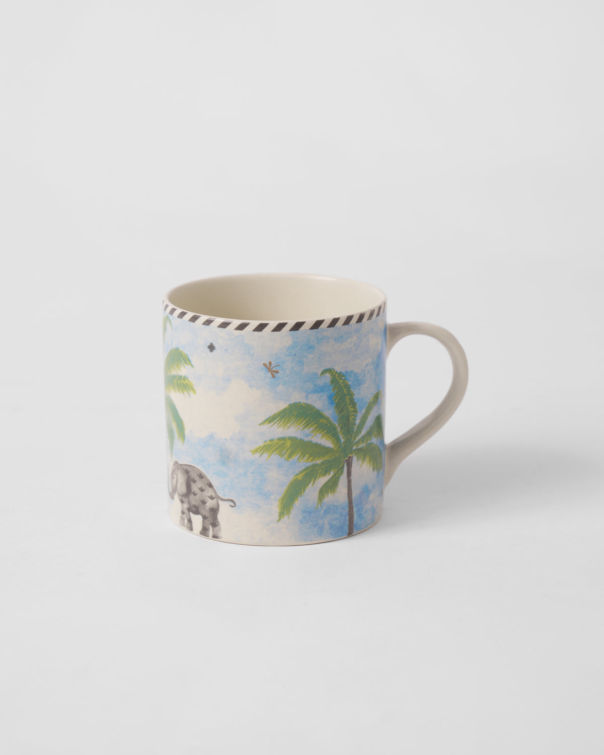 Side view of Kandy Straight Mug with a palm tree and a grey elephant.