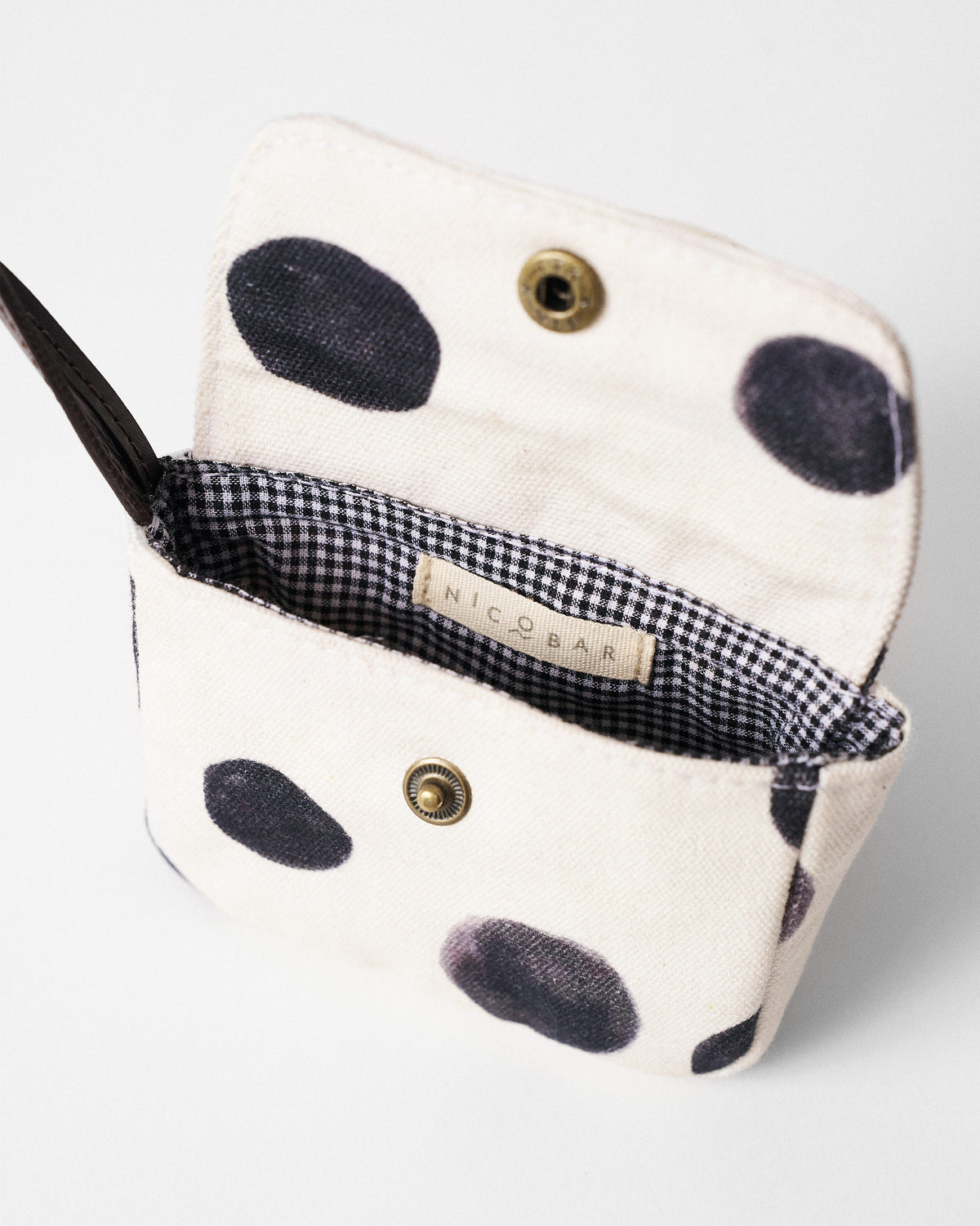 Open Polka Coin Pouch showing gingham lining, brass snap, and charcoal dots.