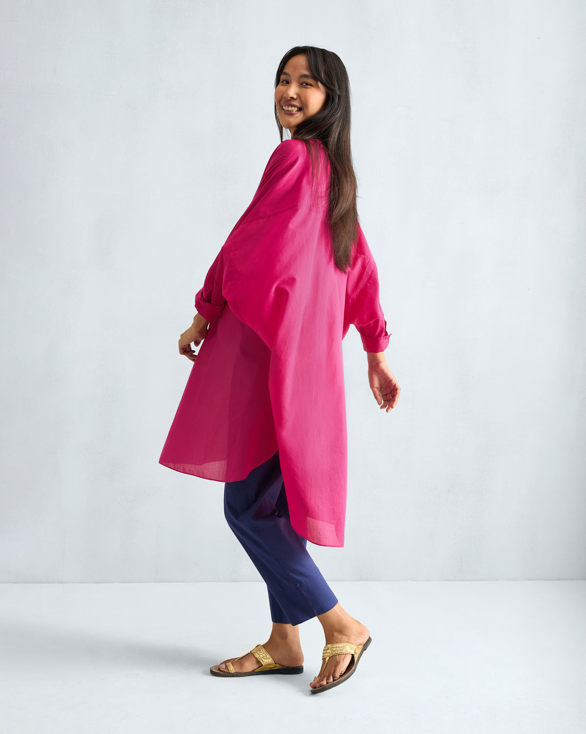 Back of a fuchsia Lazy Sunday tunic worn by a person.