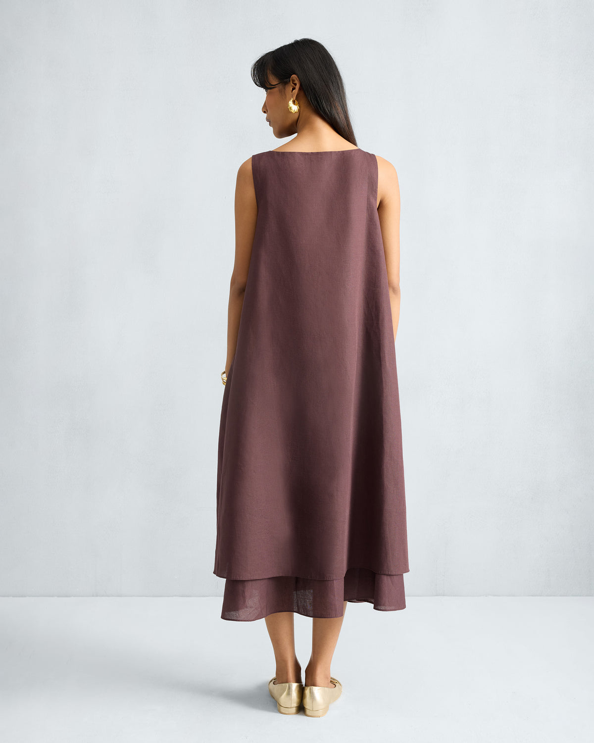 Back of a chocolate plum Double Layer Dress with a layered midi hem.