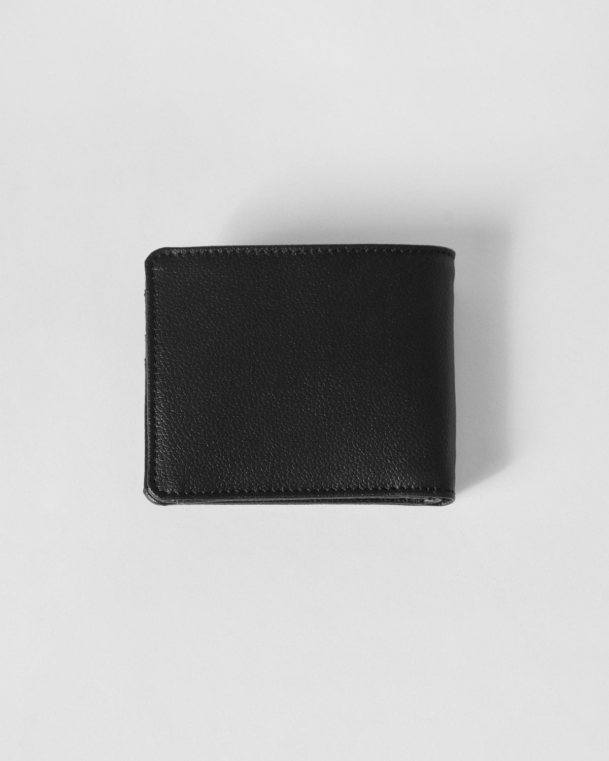 Back of a black Classic Bi-Fold Wallet in pebbled leather.