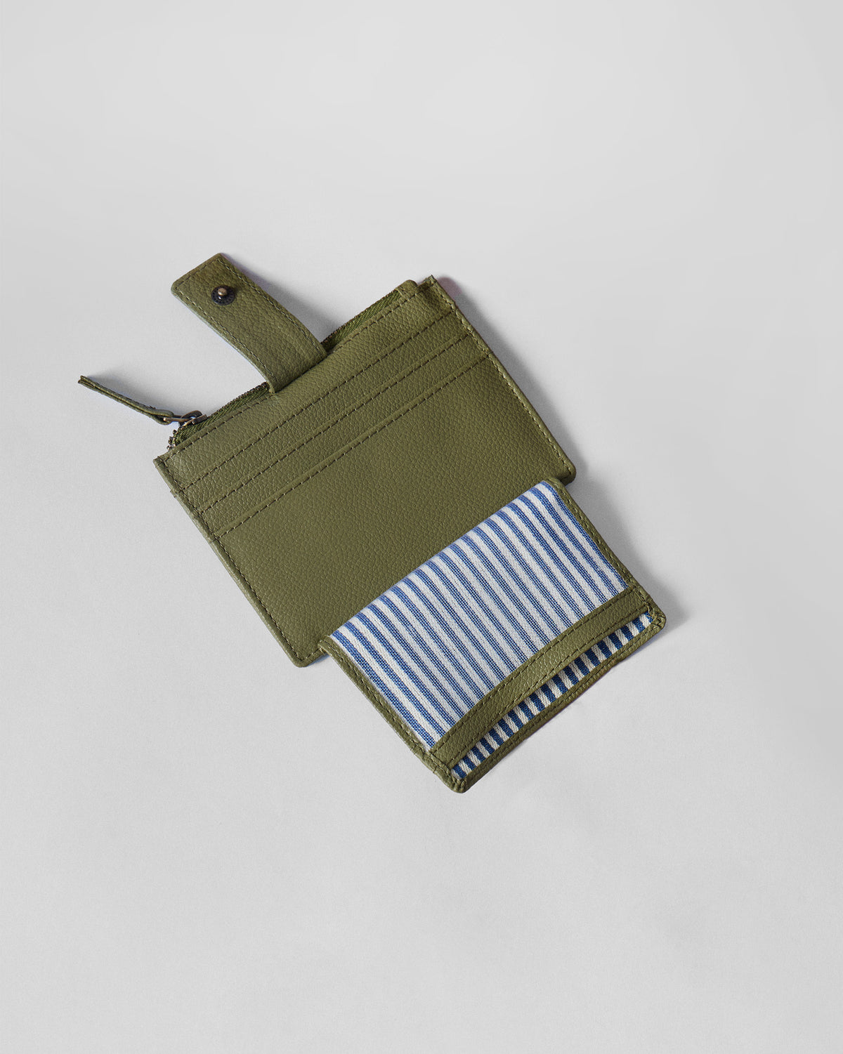 Open green Everyday Star card holder showing a blue-and-white striped lining.