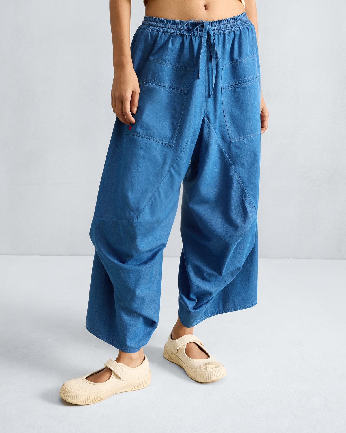 Denim blue Yoka Trousers with a flared silhouette.