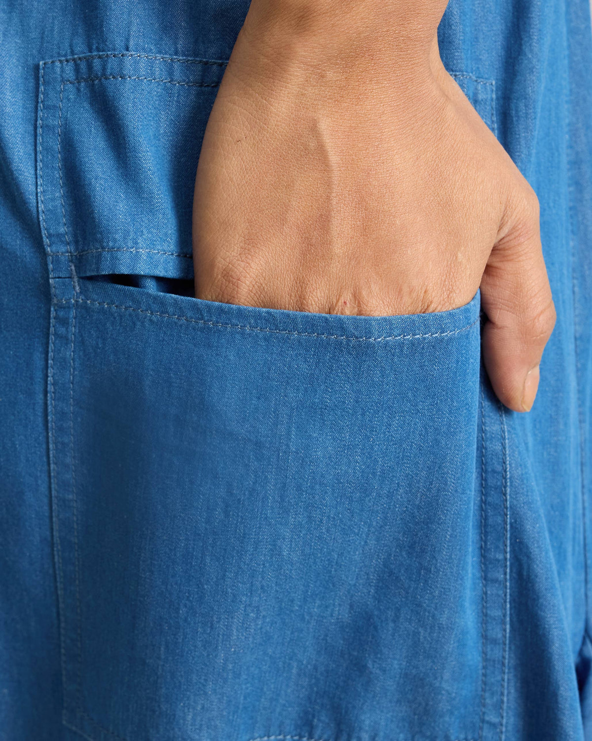 Close-up of a deep patch pocket on denim Yoka Trousers.