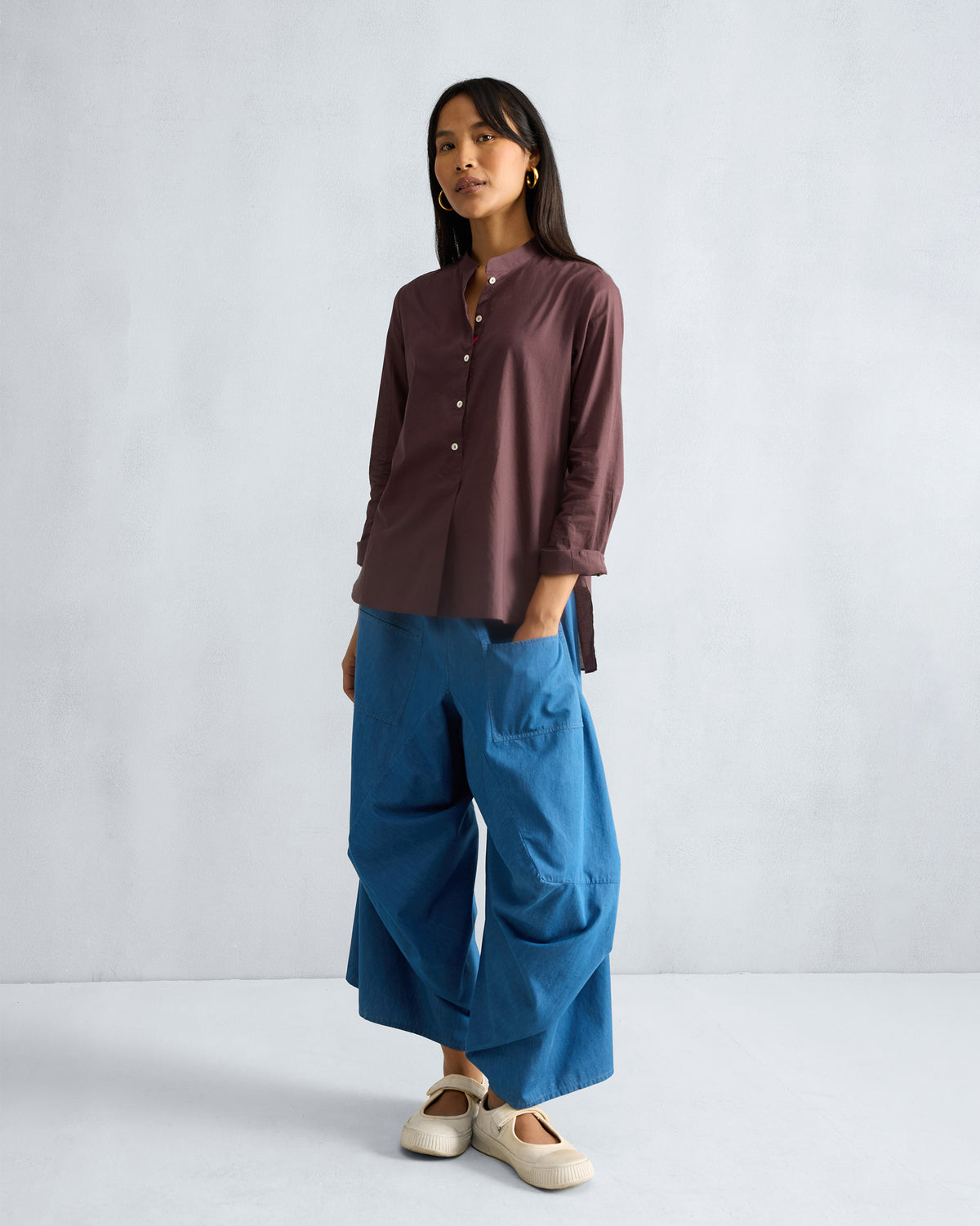 Person wearing denim blue Yoka Trousers.