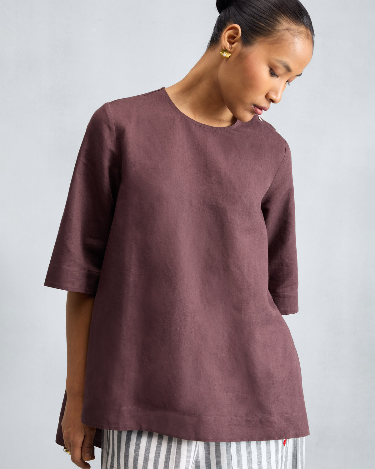 Person wearing a chocolate plum High Slit Top with elbow sleeves.