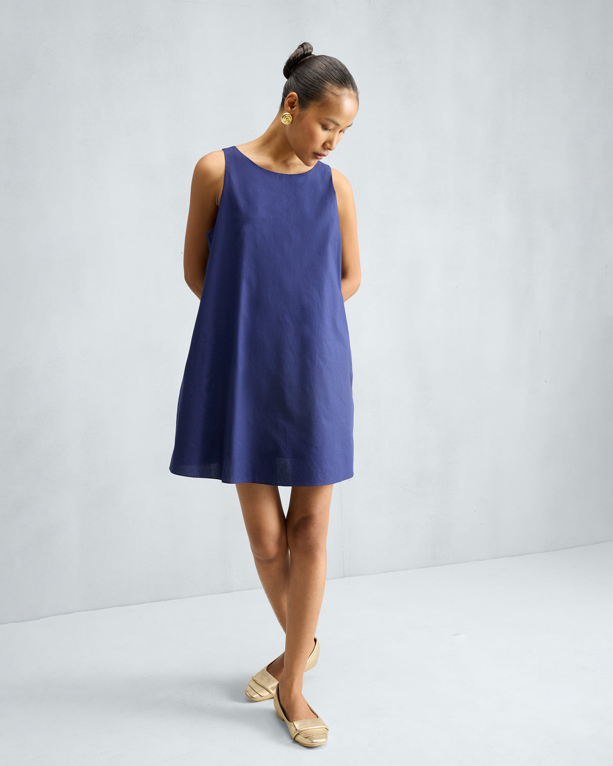 Person wearing an ink blue short racerback dress.
