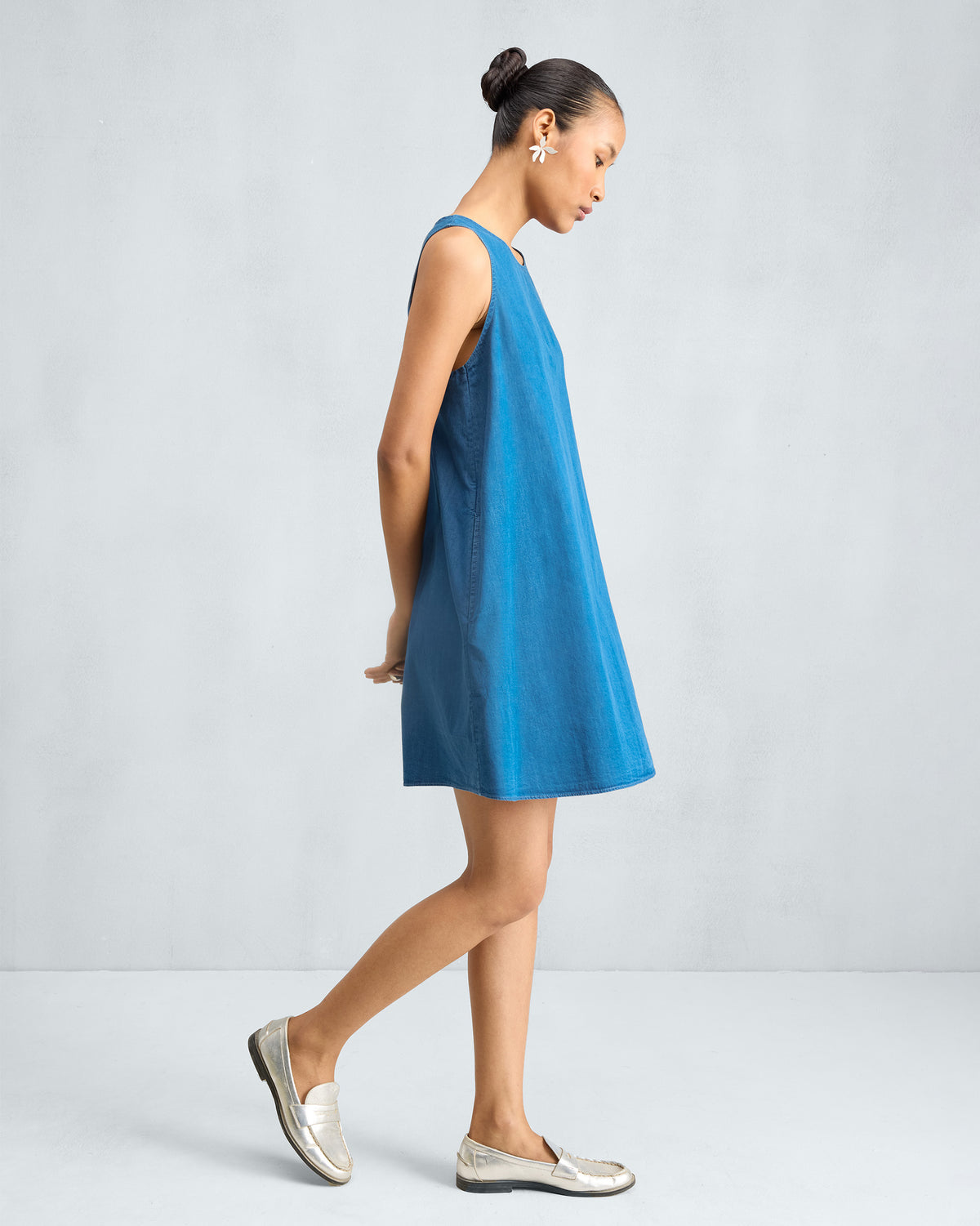 Side view of a denim short racerback dress.