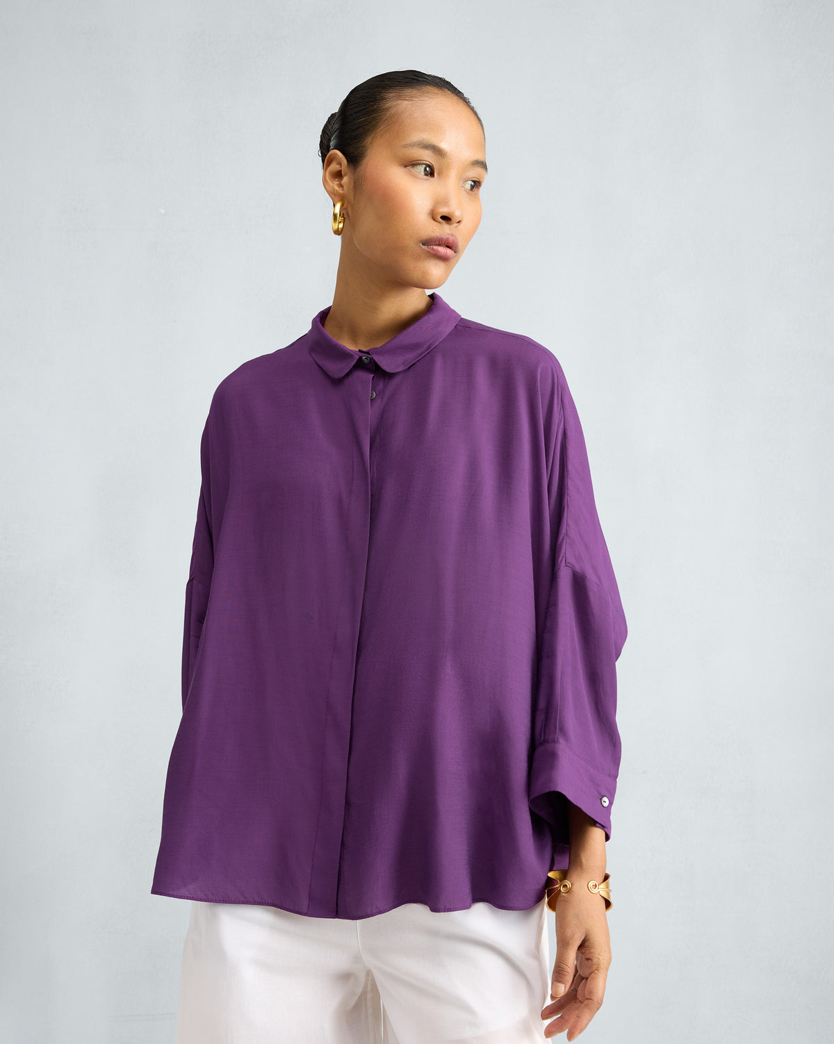 Person wearing a purple Boxy shirt with a relaxed oversized fit.