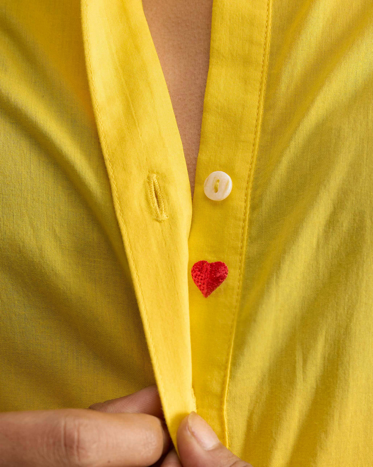 Close-up of a red heart embroidery inside a yellow Basic Long Kurta placket.