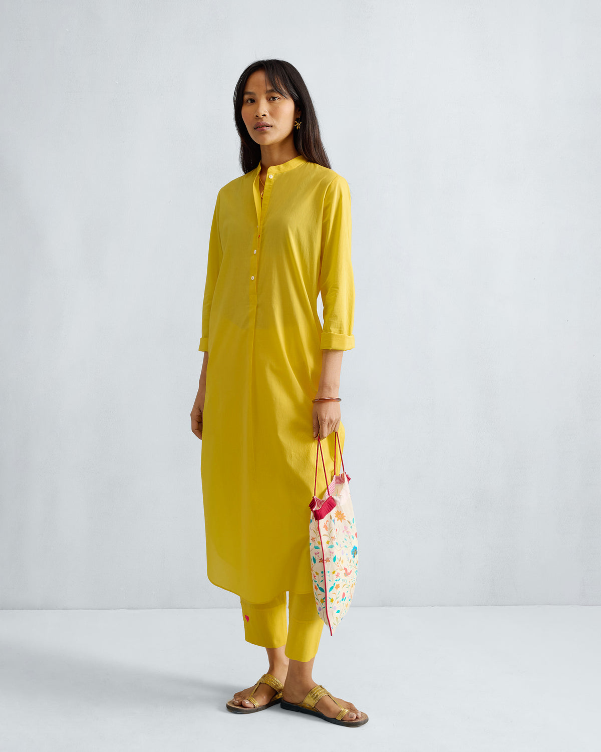 Person wearing a full-length yellow Basic Long Kurta.