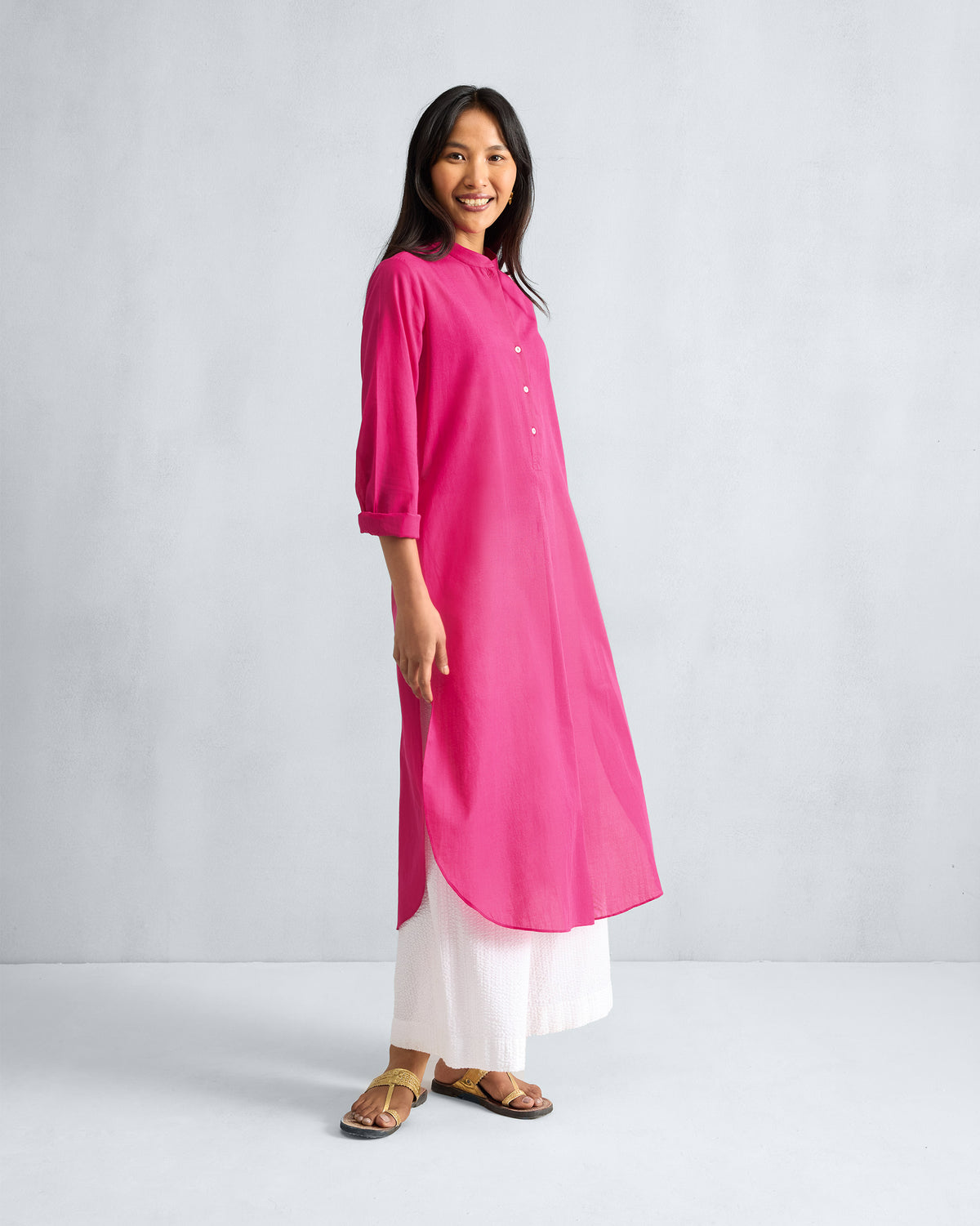 Fuchsia Basic Long Kurta worn with side slits visible at three-quarter angle.
