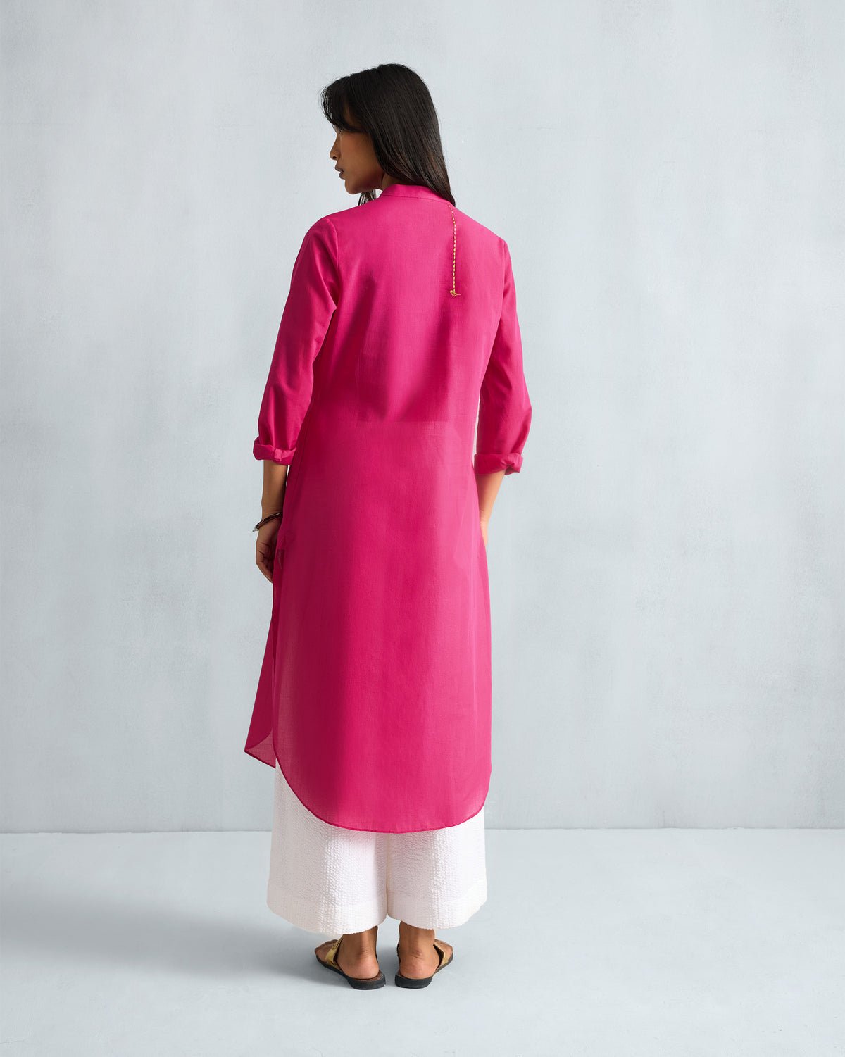 Back of a fuchsia Basic Long Kurta with a long curved hem.