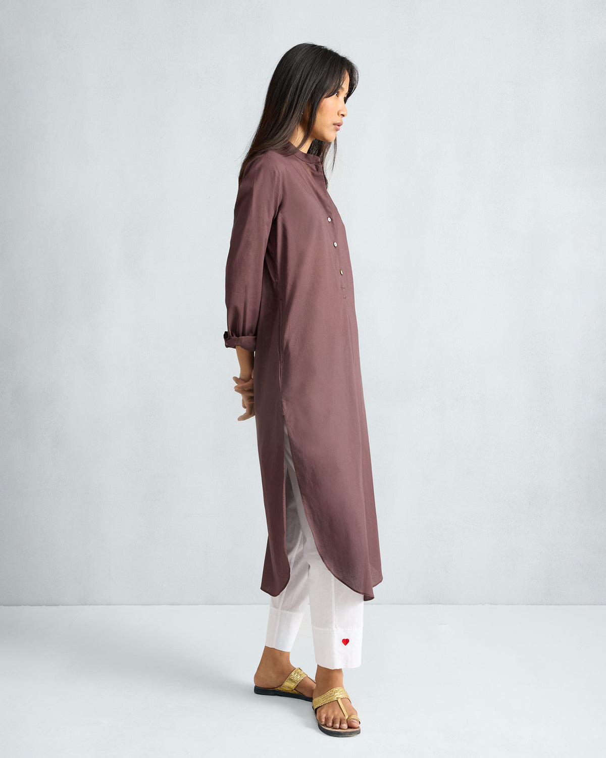 Side view of a chocolate plum long kurta with mandarin collar and side slits.