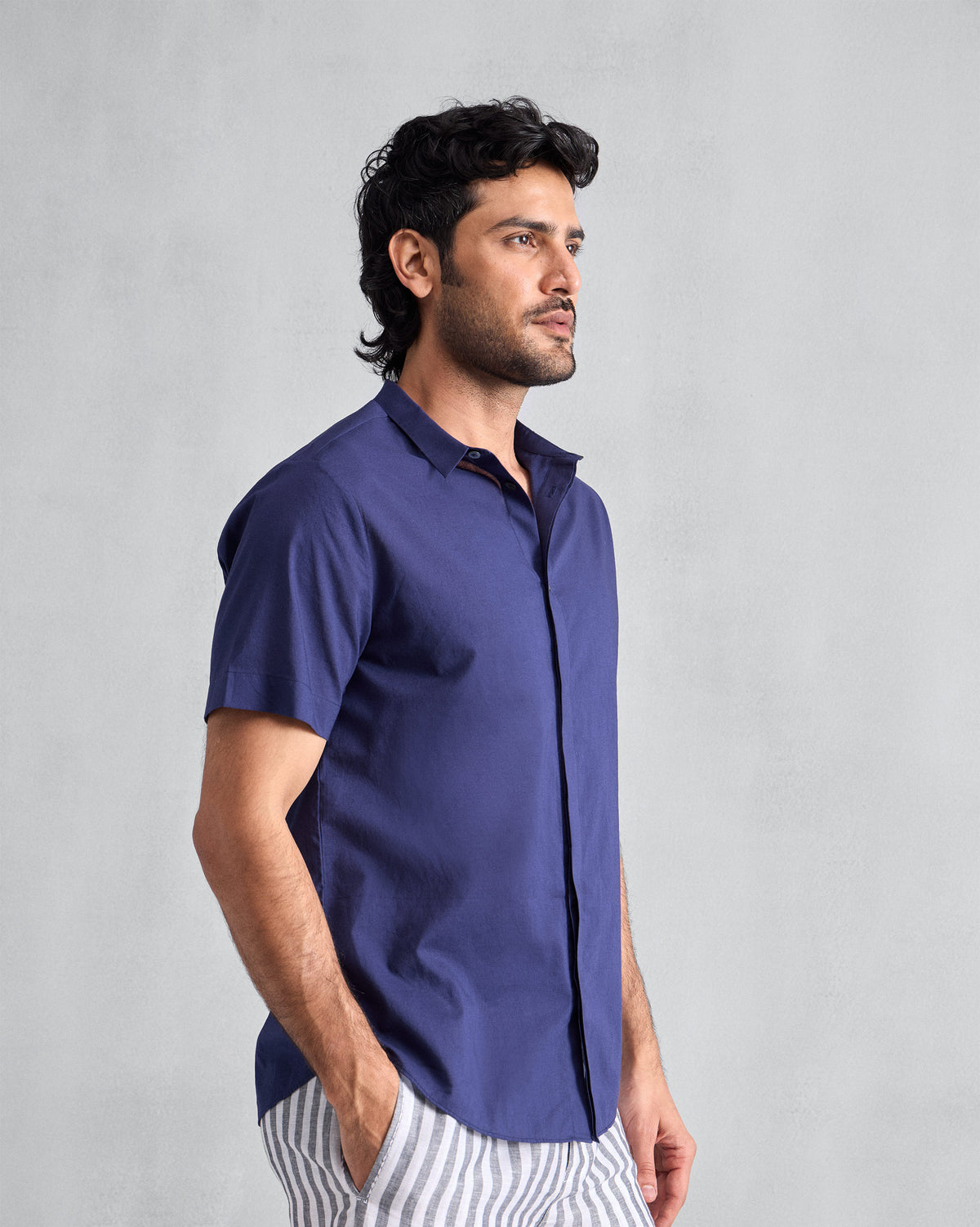 Side view of an ink blue short-sleeve Riverine Shirt.