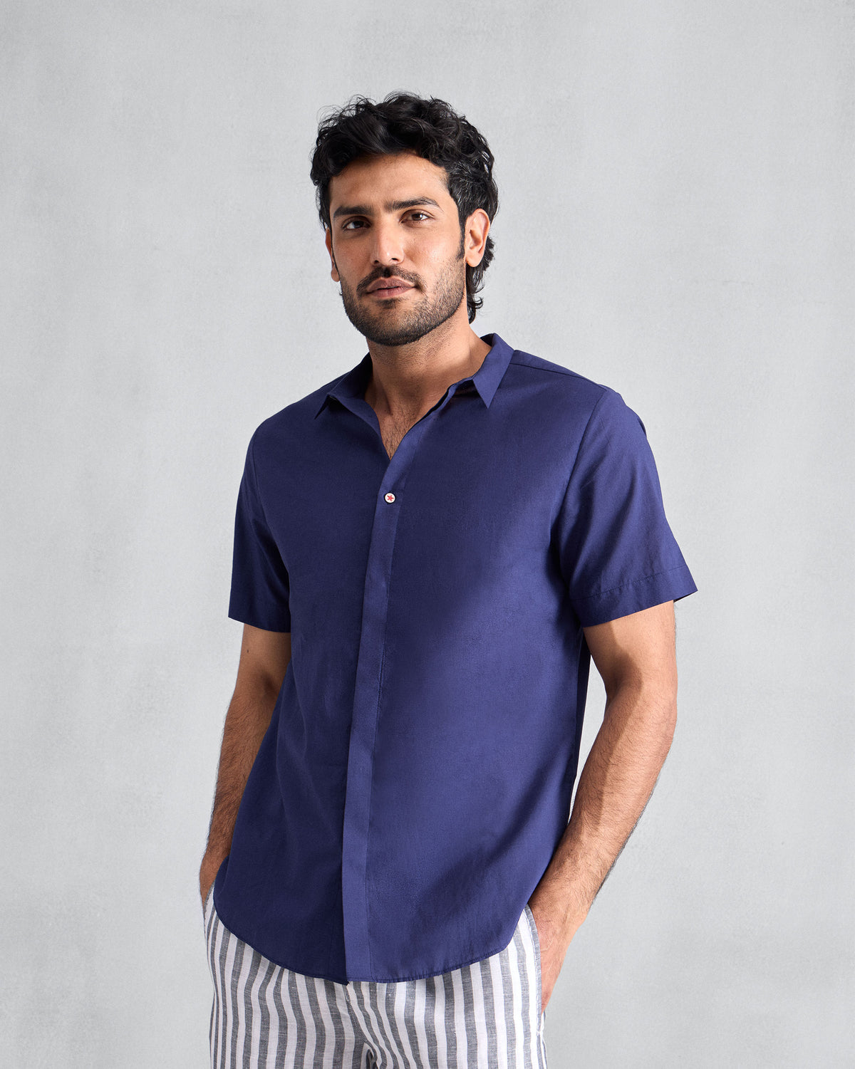 Person wearing an ink blue short-sleeve Riverine Shirt.