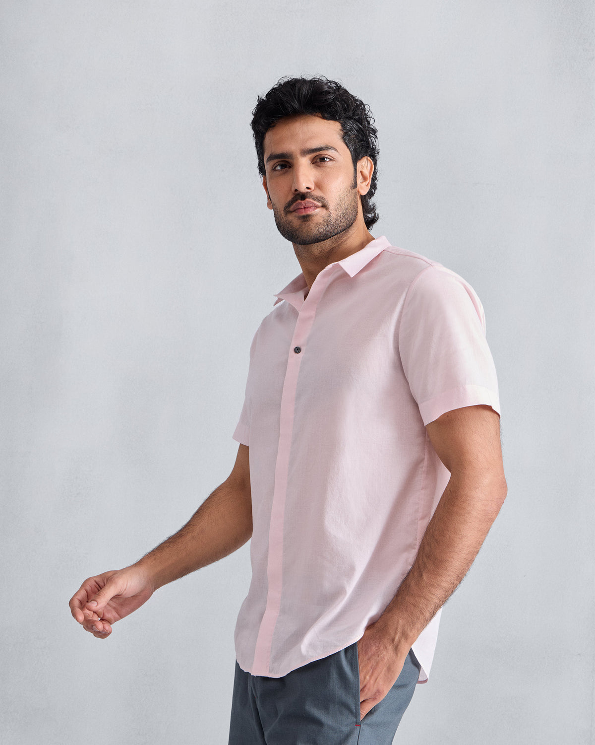 Person wearing a pink Riverine Shirt with a classic collar.