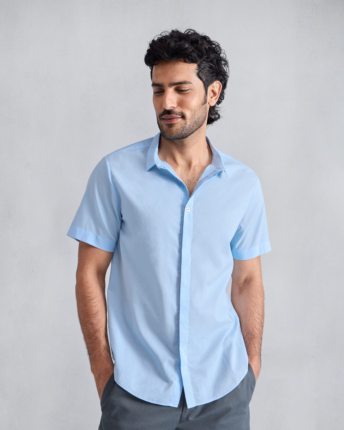 Person wearing a light blue short-sleeve Riverine shirt.