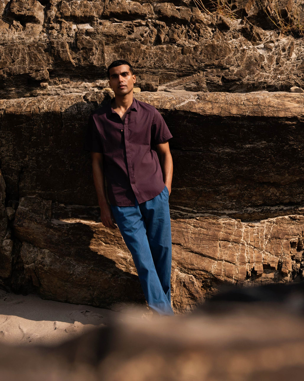 Person wearing a chocolate plum Riverine shirt outdoors.