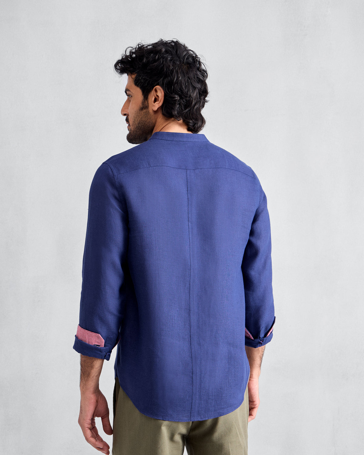 Back of an ink blue Nawab shirt with pink cuff lining.