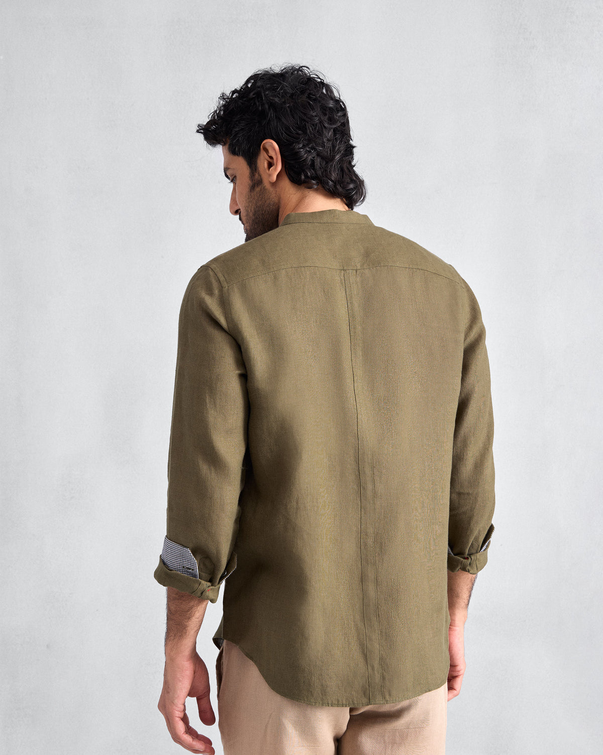 Back of an olive Nawab Shirt with a Nehru collar and centre back seam.