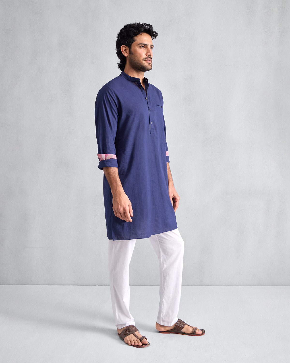 Side view of an ink blue Pondicherry Kurta showing mid-thigh length and rolled sleeves.
