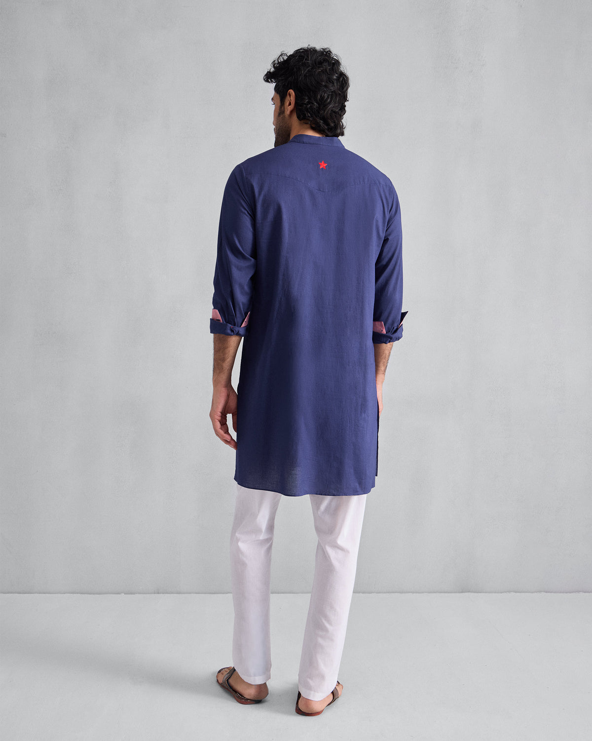 Back of an ink blue Pondicherry Kurta with a red star below the collar.