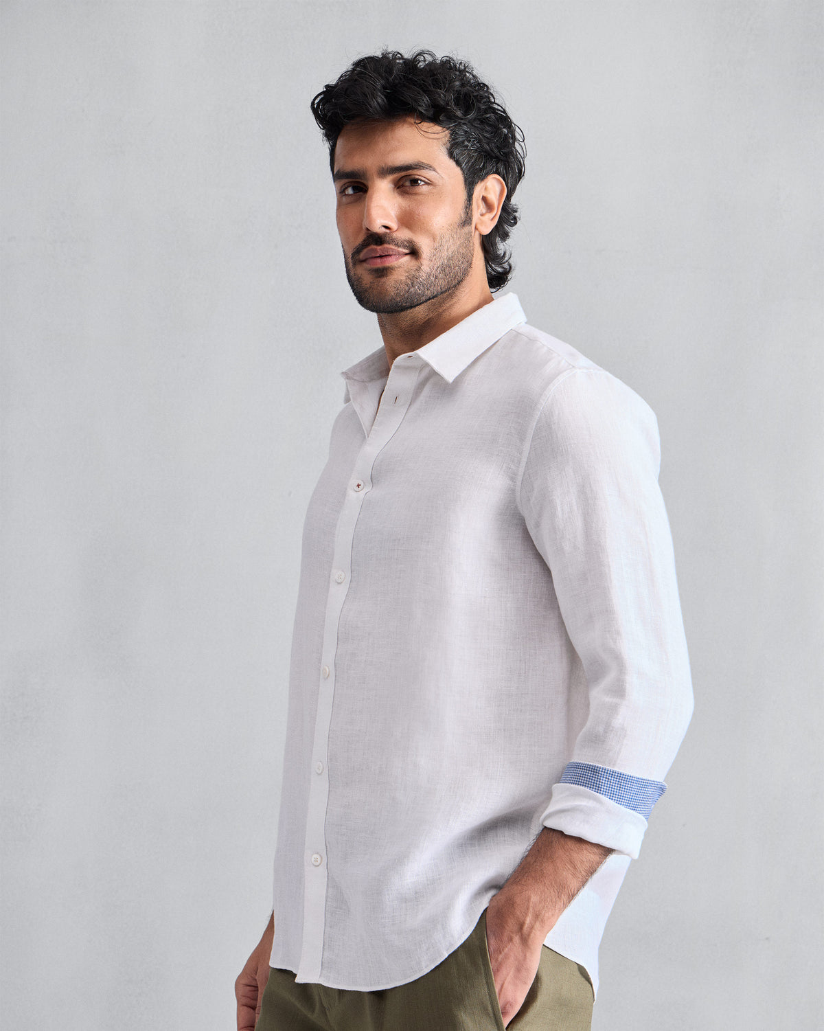 Person wearing a white Classic shirt with blue cuff lining.