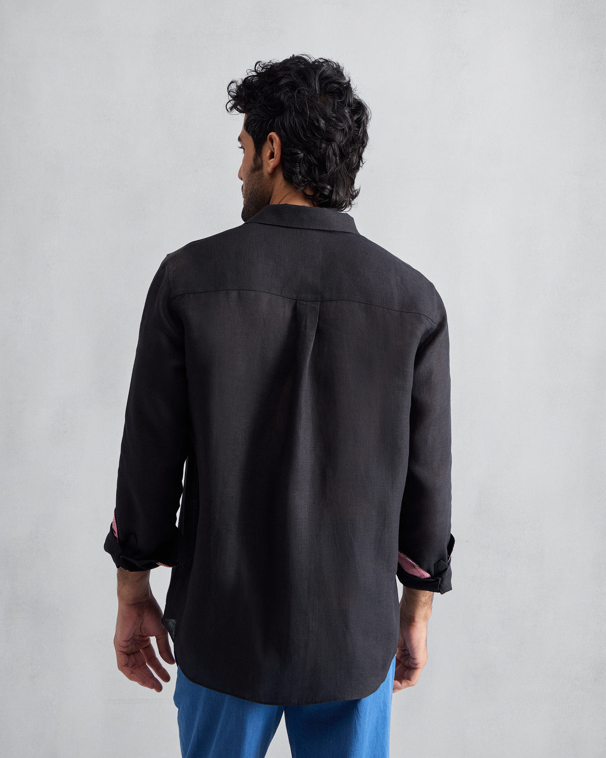 Back of a black Classic shirt with a center box pleat.